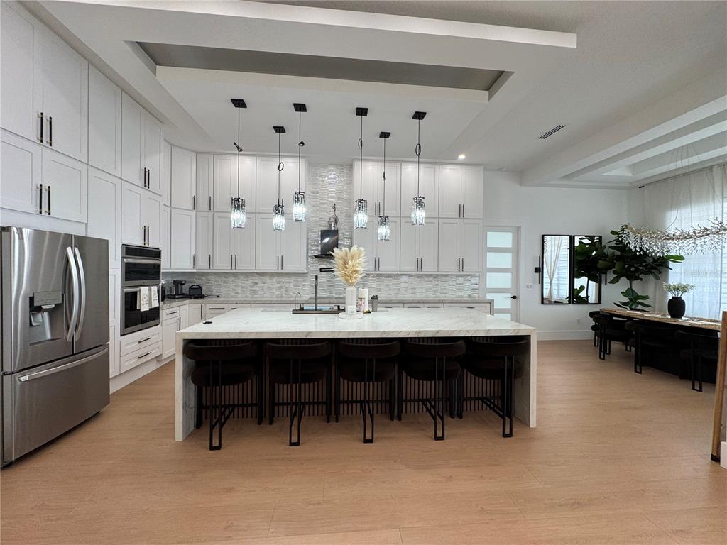 17314 Highway 41 Spring Hill, FL 34610 - Photo 12 of 54 a kitchen with stainless steel appliances a sink a stove a refrigerator and cabinets