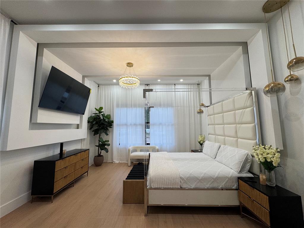 17314 Highway 41 Spring Hill, FL 34610 - Photo 19 of 54 a spacious bedroom with a bed and a flat screen television