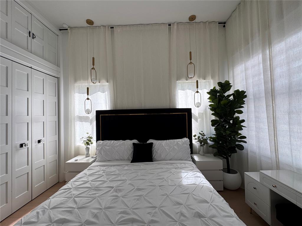 17314 Highway 41 Spring Hill, FL 34610 - Photo 26 of 54 a bedroom with a bed and a potted plant