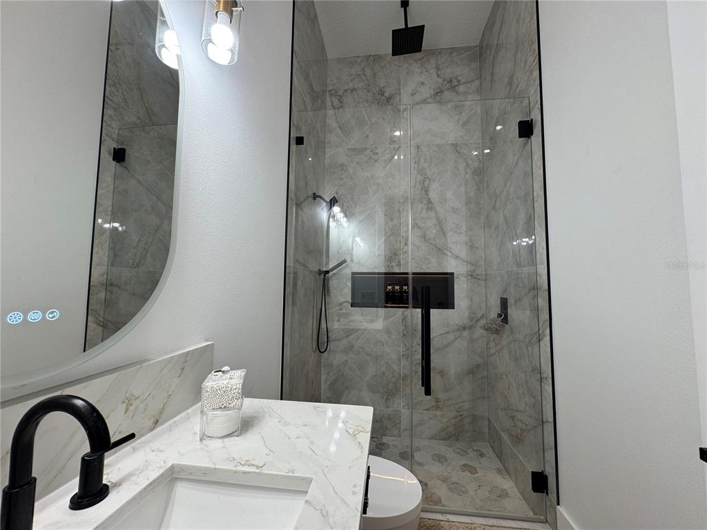 17314 Highway 41 Spring Hill, FL 34610 - Photo 29 of 54 a bathroom with a shower a toilet and a sink