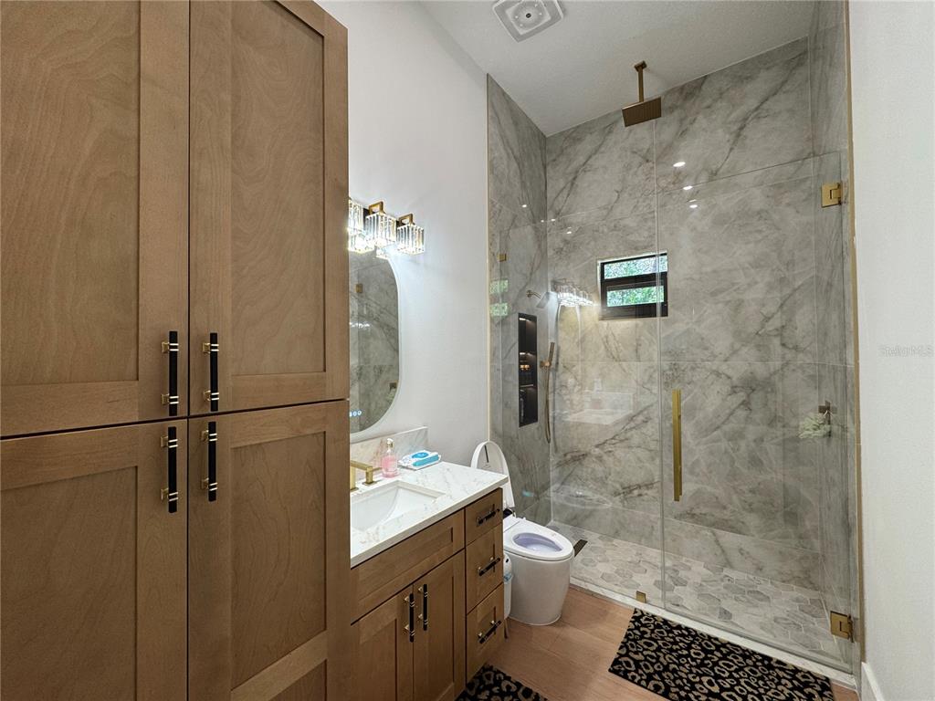 17314 Highway 41 Spring Hill, FL 34610 - Photo 34 of 54 a bathroom with a shower a toilet and sink