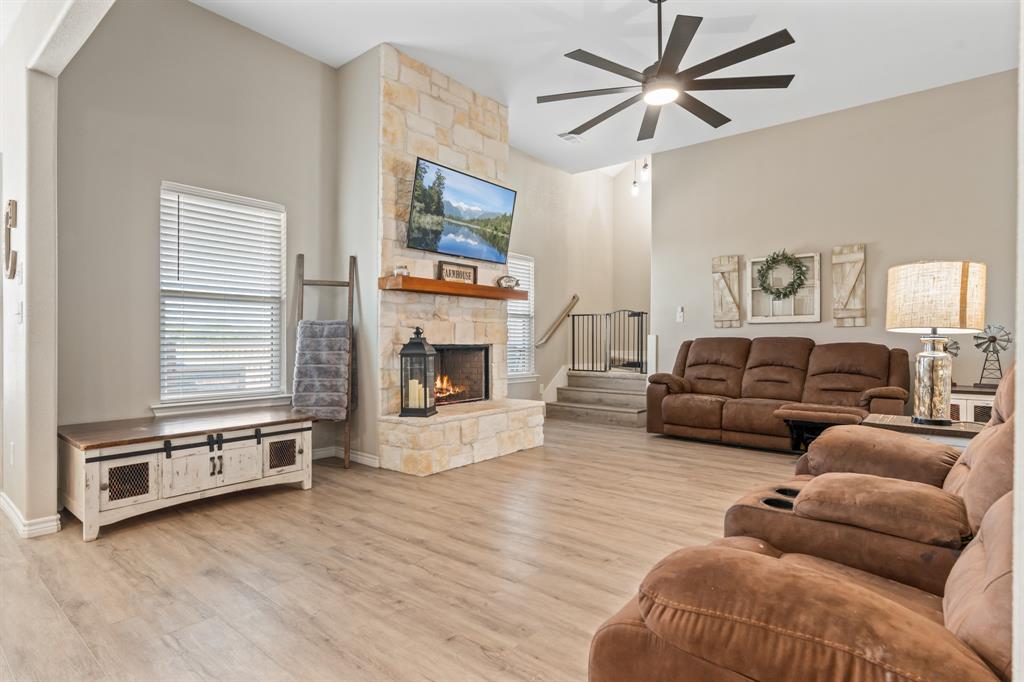 130 Private Road Hillsboro, TX 76645 - Photo 11 of 39 a living room with furniture a flat screen tv and a fireplace