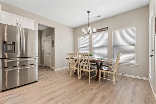 a kitchen with kitchen island wooden floor center island and stainless steel appliances