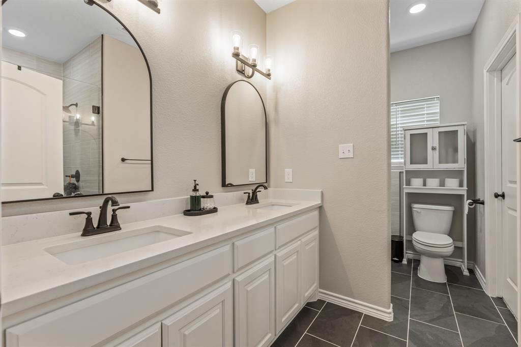 130 Private Road Hillsboro, TX 76645 - Photo 19 of 39 a bathroom with a toilet sink and mirror
