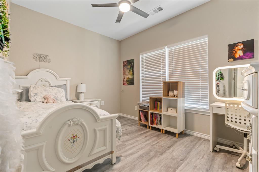 130 Private Road Hillsboro, TX 76645 - Photo 26 of 39 a bedroom with a bed and a chandelier
