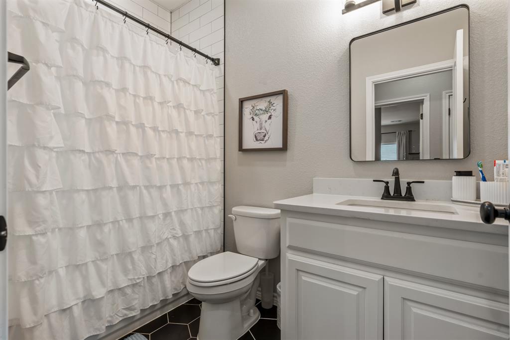 130 Private Road Hillsboro, TX 76645 - Photo 27 of 39 a bathroom with a granite countertop sink mirror vanity and toilet