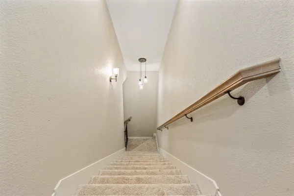 a spacious bedroom with a bed and ceiling fan