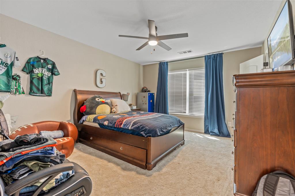 130 Private Road Hillsboro, TX 76645 - Photo 29 of 39 a spacious bedroom with a bed and a window