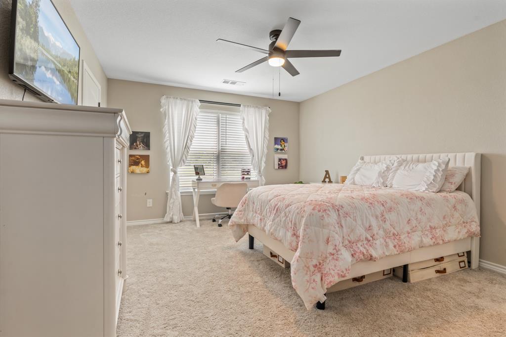 130 Private Road Hillsboro, TX 76645 - Photo 30 of 39 a spacious bedroom with a bed and ceiling fan
