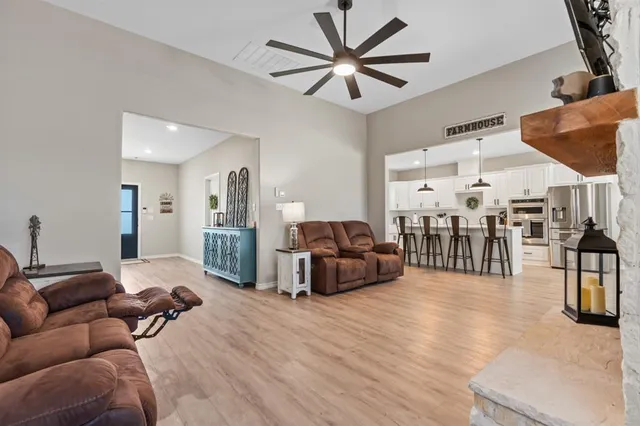 a living room with furniture a flat screen tv and a fireplace
