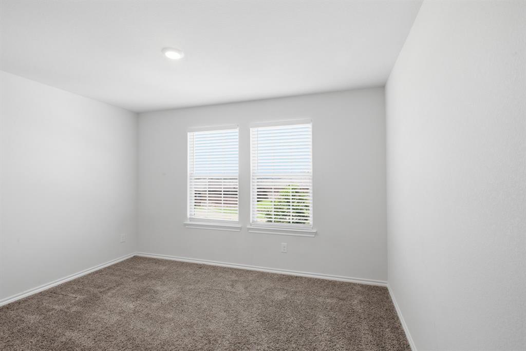 1328 Broaddus Road Forney, TX 75126 - Photo 27 of 31 Light-filled room featuring two windows with blinds, recessed ceiling lighting, textured white walls, and neutral-toned carpet flooring