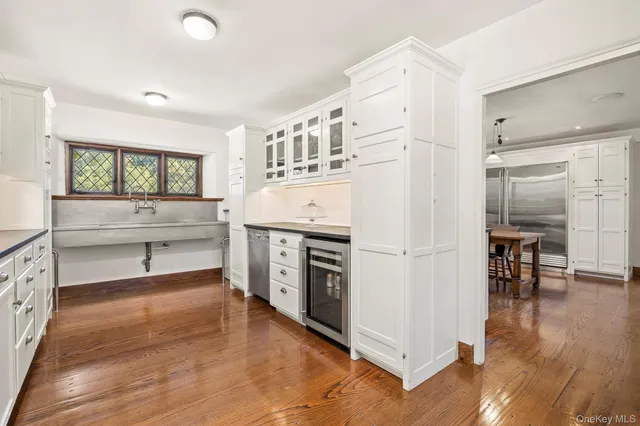 a kitchen with stainless steel appliances a white cabinets and a wooden floors