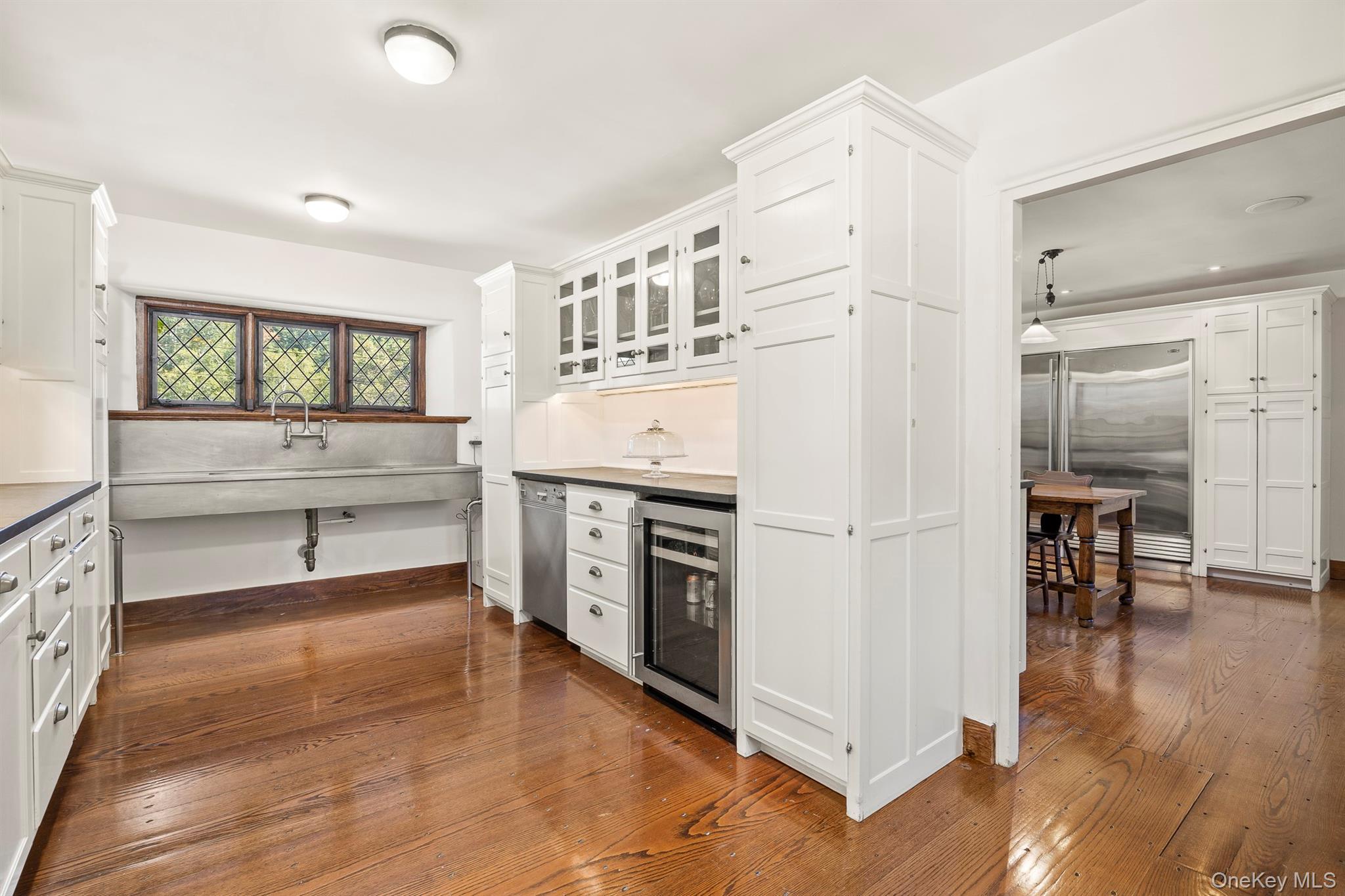 99 Quaker Bridge Road Croton-on-Hudson, NY 10520 - Photo 13 of 50 a kitchen with stainless steel appliances a white cabinets and a wooden floors