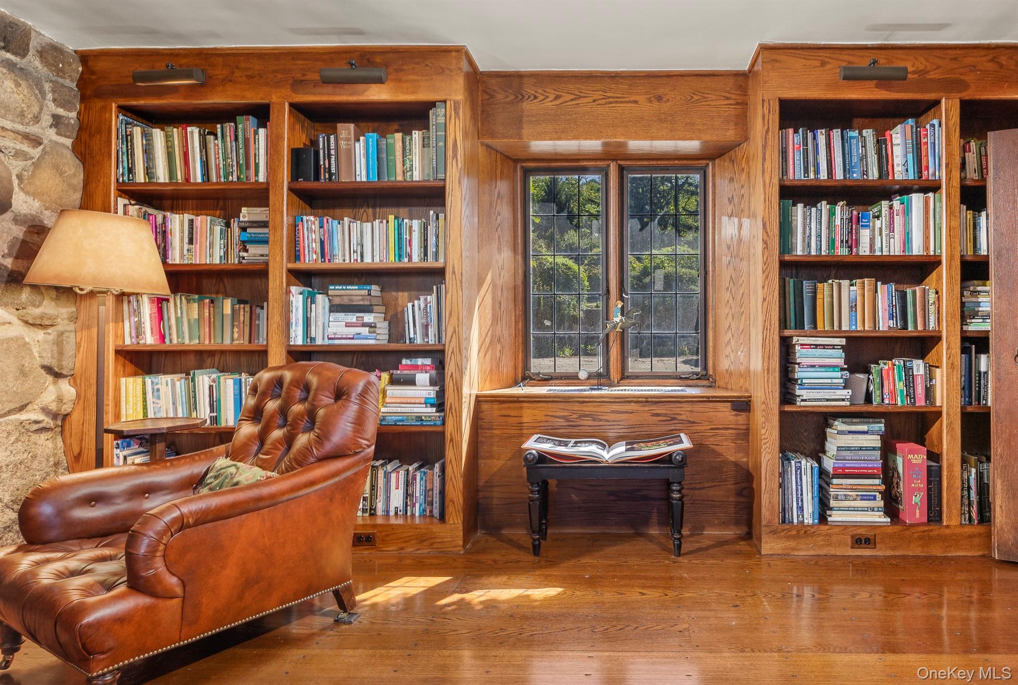 99 Quaker Bridge Road Croton-on-Hudson, NY 10520 - Photo 18 of 50 a living room with furniture and a book shelf