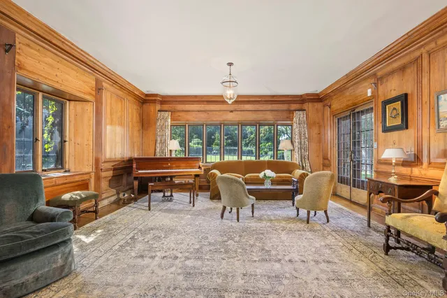 a living room with furniture and large windows
