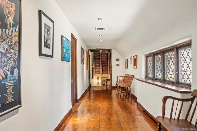 a view of a living room with furniture and wooden floor