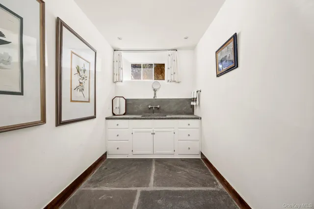 a spacious bathroom with a granite countertop sink and a mirror