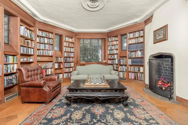 a living room with furniture a bookshelf and a table
