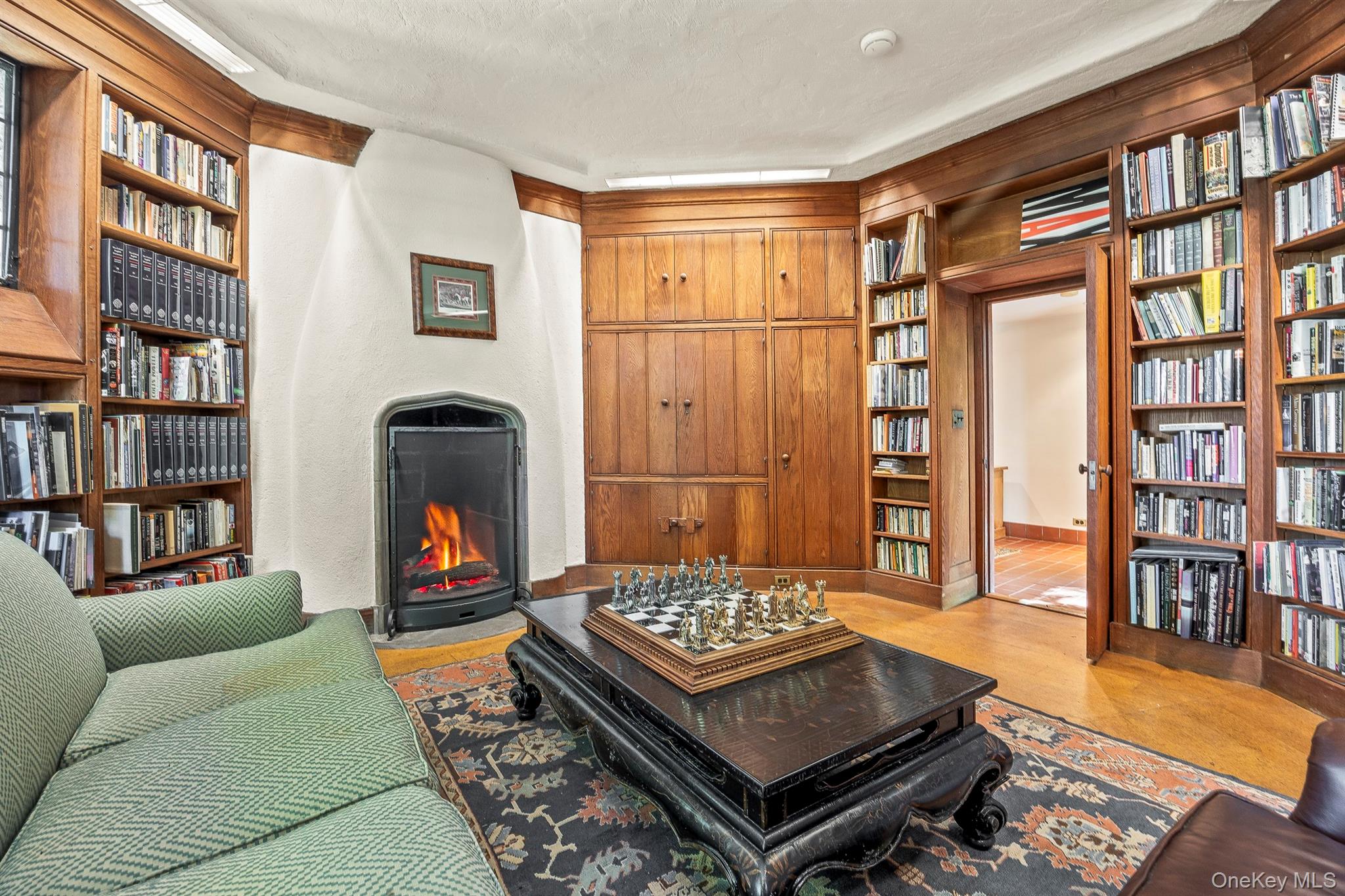 99 Quaker Bridge Road Croton-on-Hudson, NY 10520 - Photo 43 of 50 a living room with furniture a bookshelf and a table