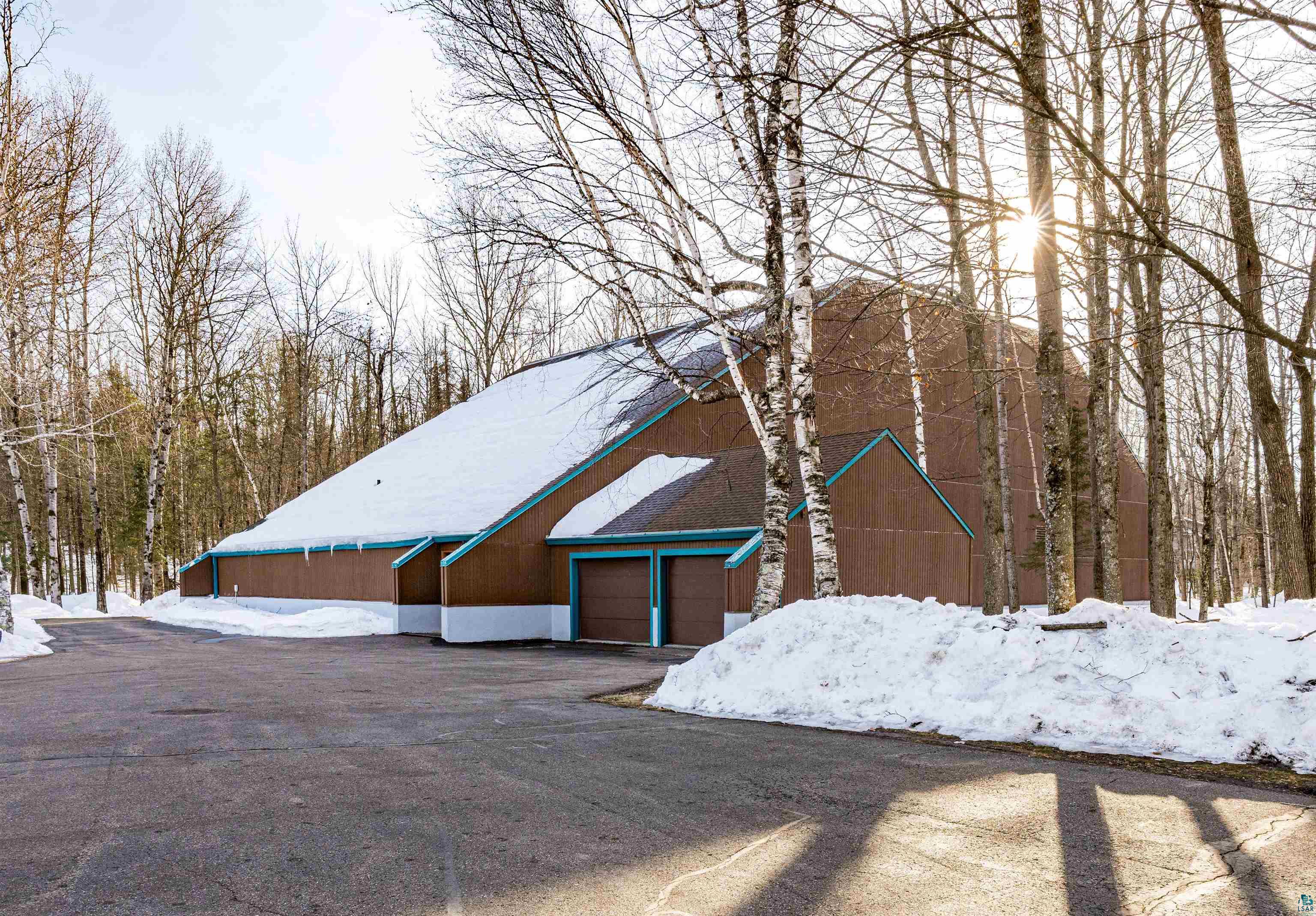 5781 South Pike Lake Road Duluth, MN 55811 - Photo 23 of 42 View of snow covered exterior with a garage and asphalt driveway