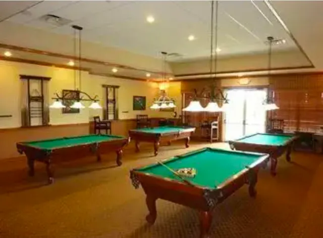 a room with pool table table and chairs