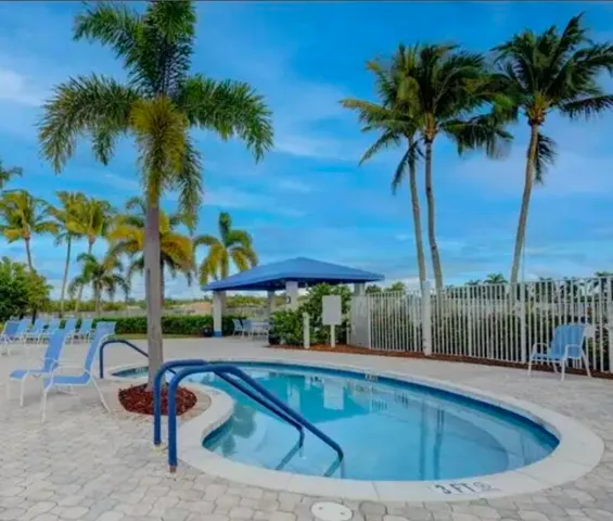a view of swimming pool with a table and chairs