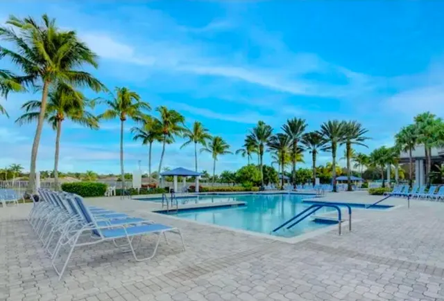 a view of swimming pool with a table and chairs