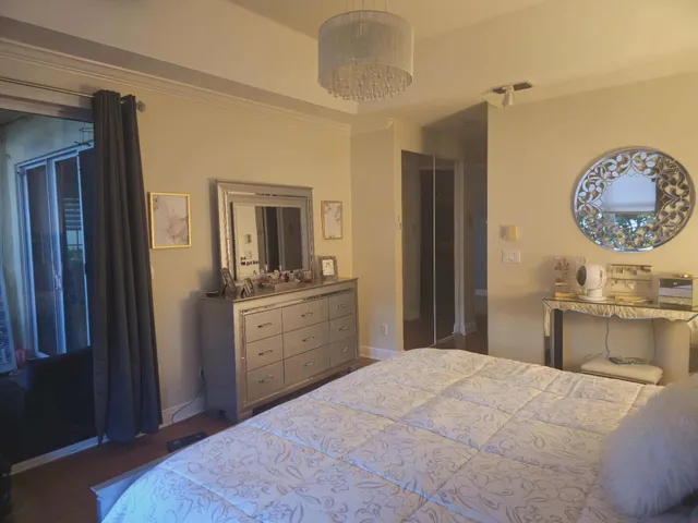 a bedroom with a bed and a chandelier