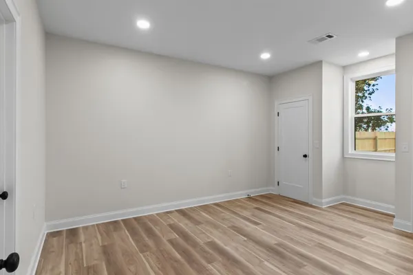 a view of room with wooden floor and window