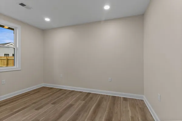 a view of room with wooden floor and fan