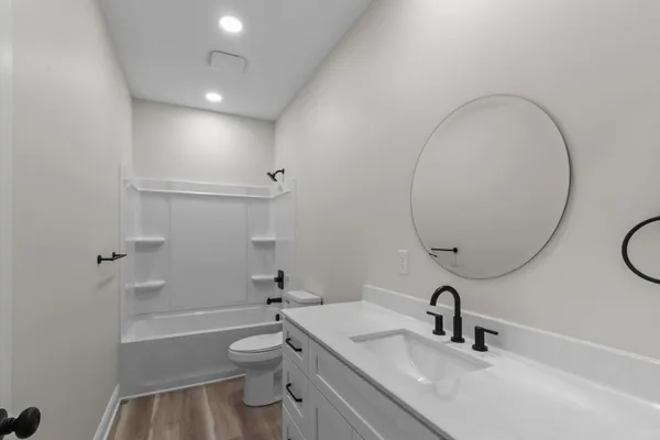 a bathroom with a sink a toilet and a mirror