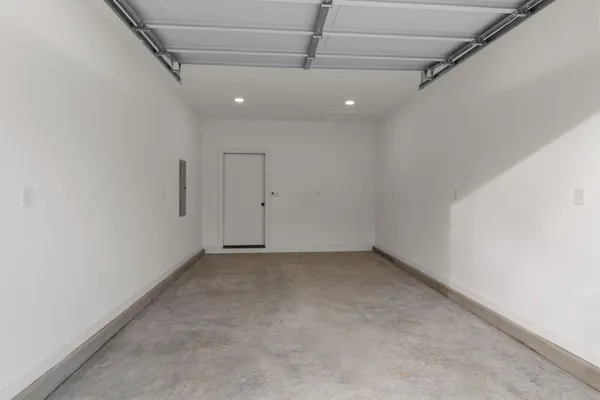 an empty room with a ceiling fan and window