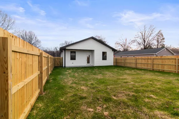 a view of a house with a backyard