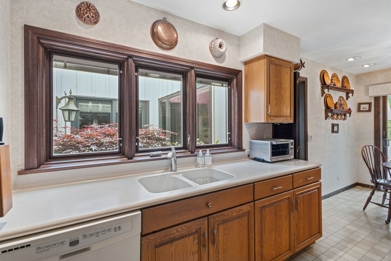 715 Tomlin Drive, Unit A1 Burr Ridge, IL 60527 - Photo 12 of 24 a view of a sink a mirror and a clock on the wall