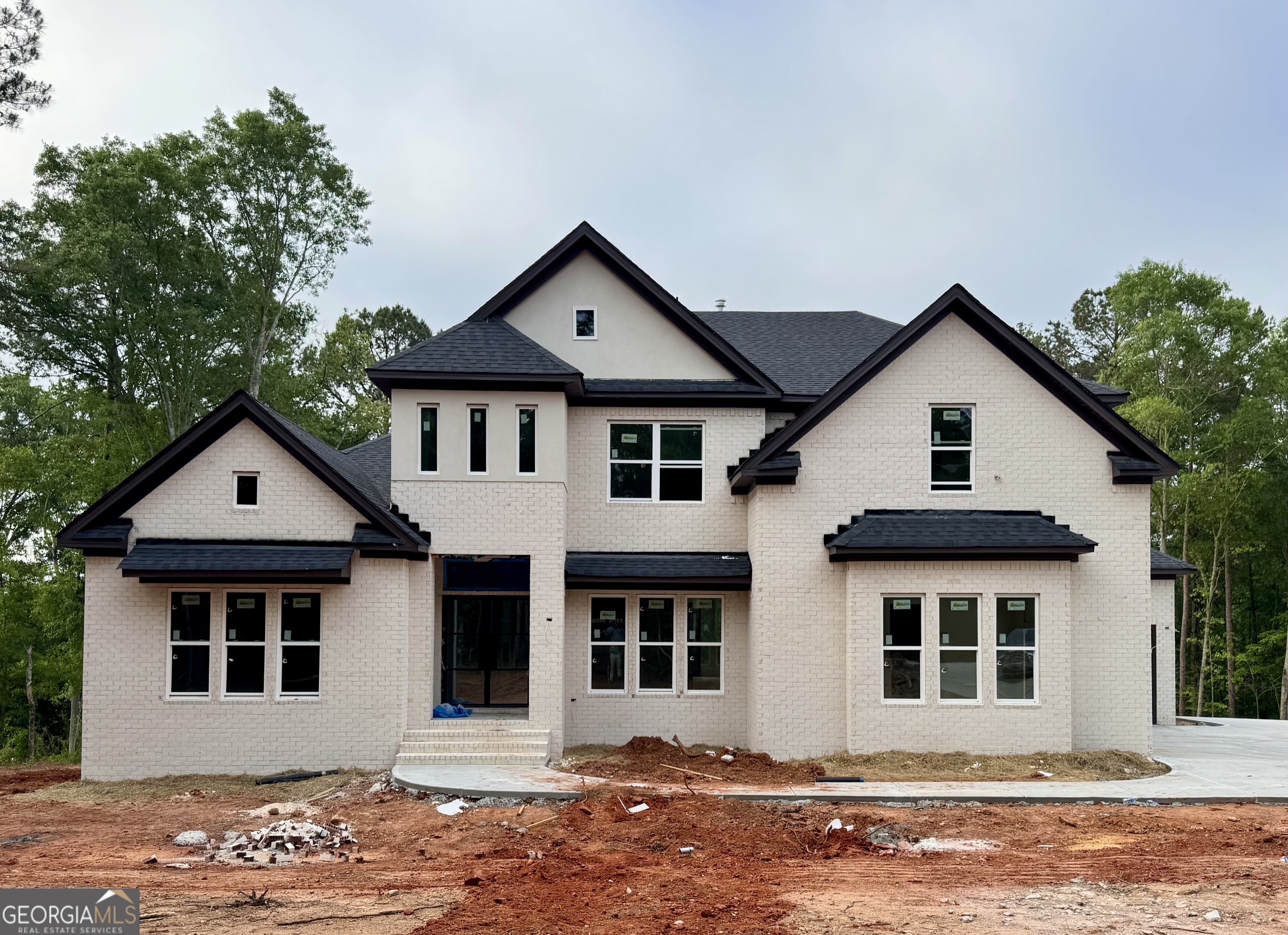 1290 New Hope Church Road, Unit 5 Loganville, GA 30052 - Photo 1 of 3 a front view of a house with a yard