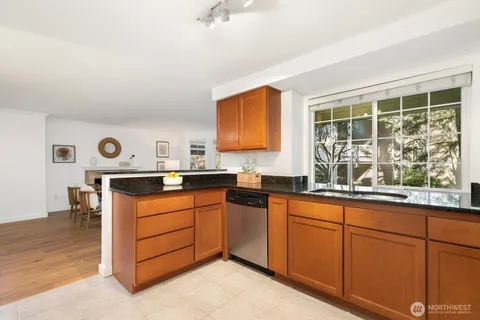 a kitchen with stainless steel appliances granite countertop a sink stove and cabinets
