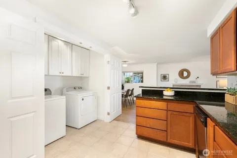 a kitchen with white cabinets and appliances