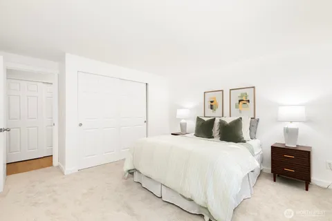 a bedroom with a bed and a night stand