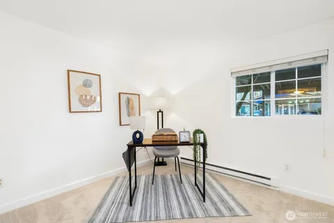 a view of a workspace with furniture and wooden floor