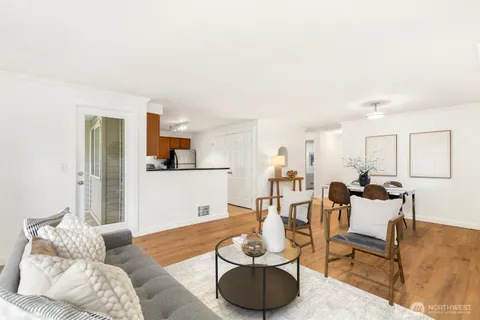 a living room with furniture and kitchen view