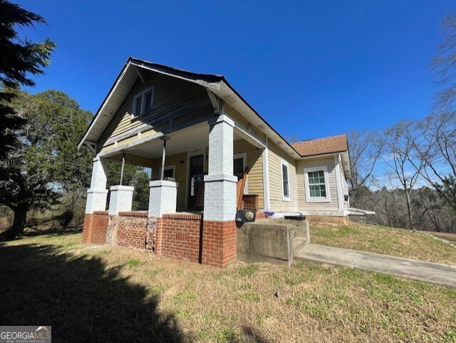 6070 Riggins Mill Road Dry Branch, GA 31020 - Photo 1 of 19 a front view of a house with a yard