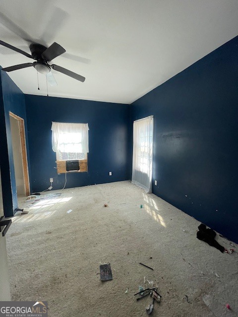 6070 Riggins Mill Road Dry Branch, GA 31020 - Photo 4 of 19 en empty room with windows and ceiling fan