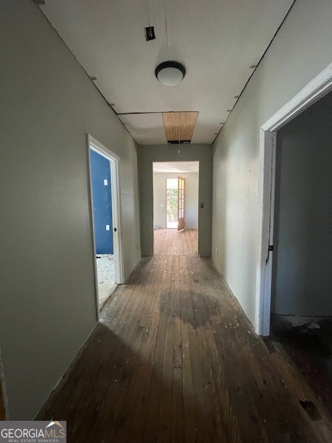 6070 Riggins Mill Road Dry Branch, GA 31020 - Photo 10 of 19 a view of a hallway with wooden floor and a living room