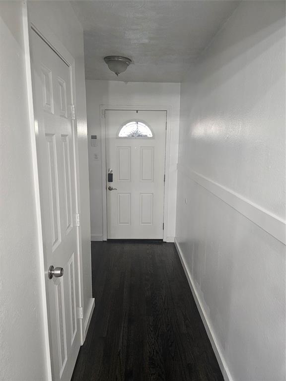 9911 Ferguson Road Dallas, TX 75228 - Photo 7 of 18 Doorway featuring wood finished floors and baseboards