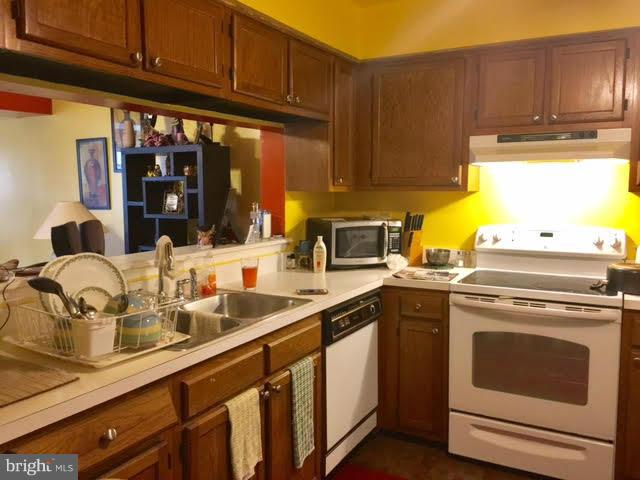 8631 Ritchboro Road District Heights, MD 20747 - Photo 2 of 11 a kitchen with stainless steel appliances granite countertop a sink stove and cabinets