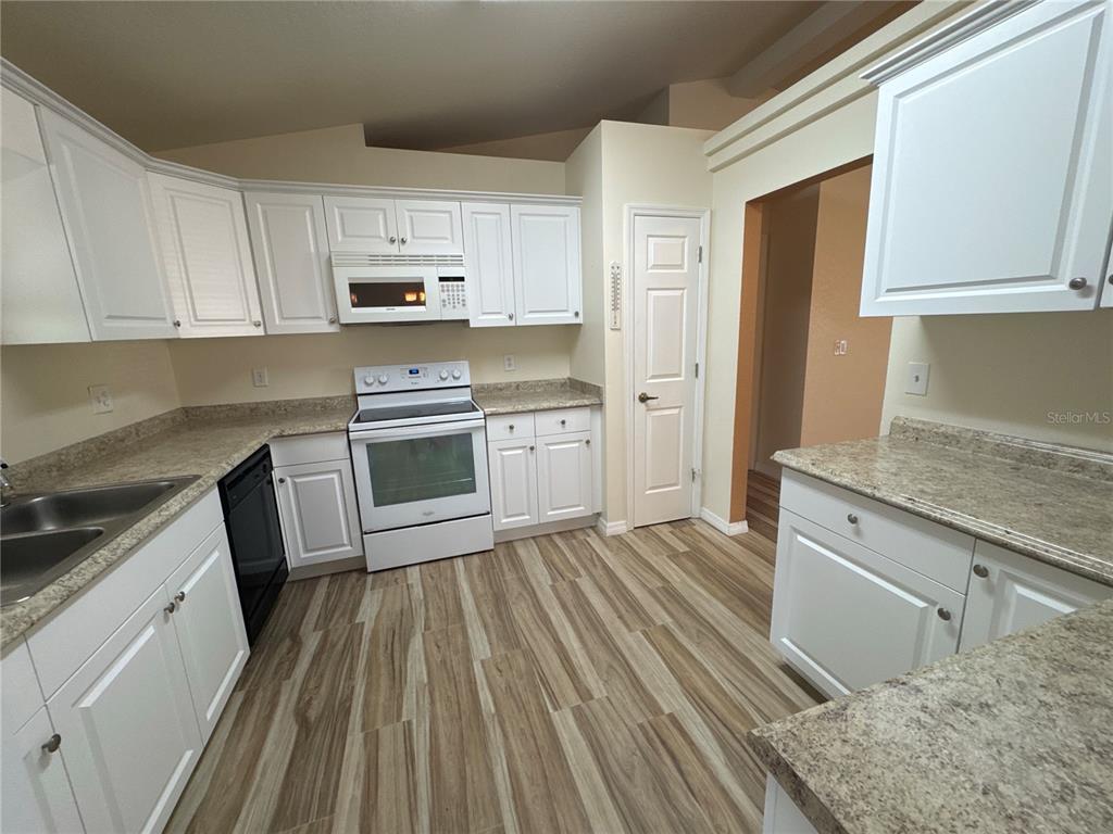 5440 Southwest 100th Loop Ocala, FL 34476 - Photo 11 of 37 a kitchen with a sink stove and refrigerator