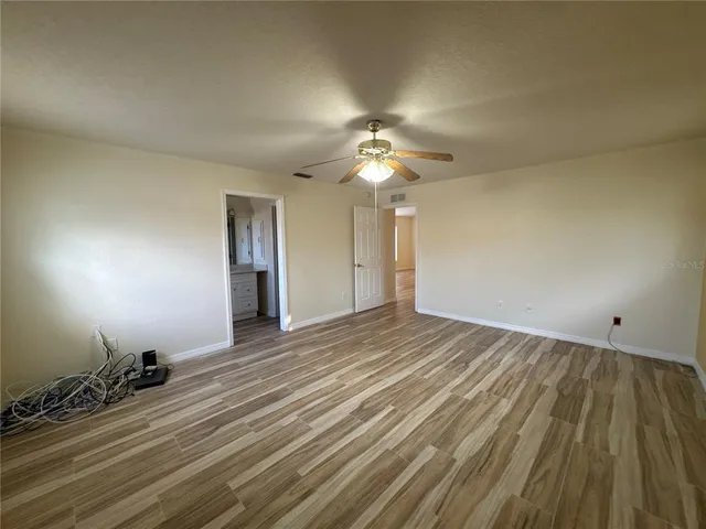 a view of an empty room and wooden floor