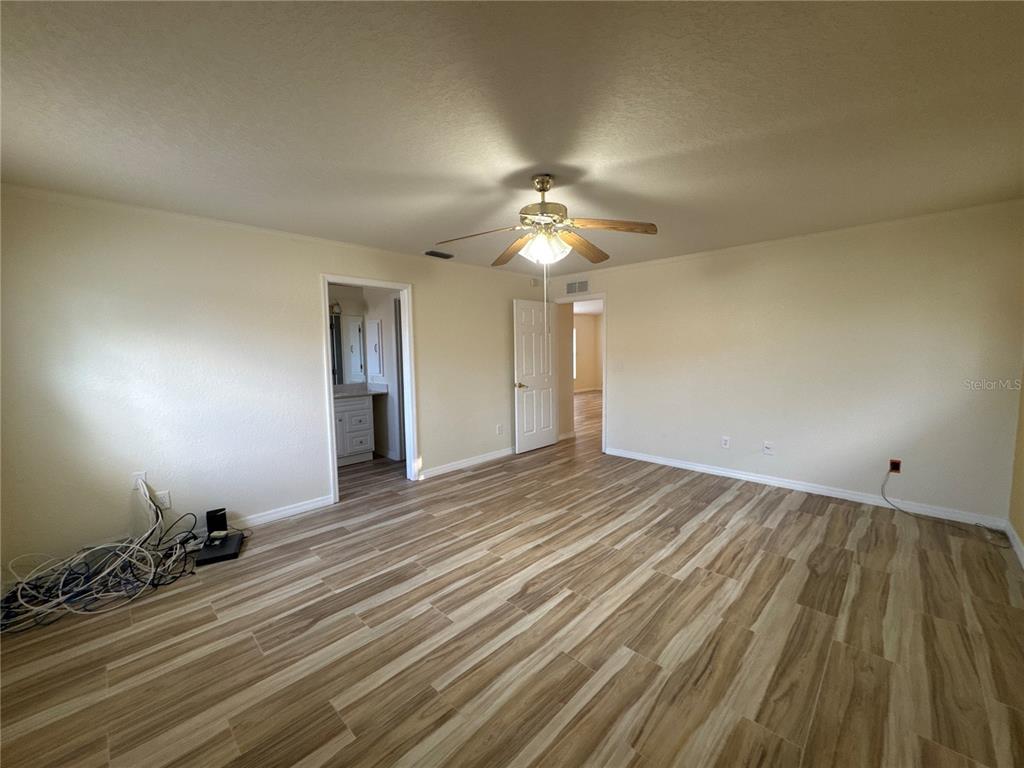 5440 Southwest 100th Loop Ocala, FL 34476 - Photo 13 of 37 a view of an empty room and wooden floor
