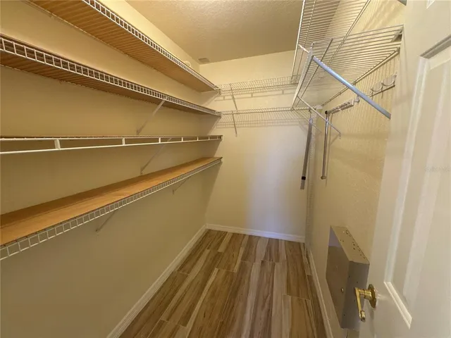 a view of a room with wooden floor
