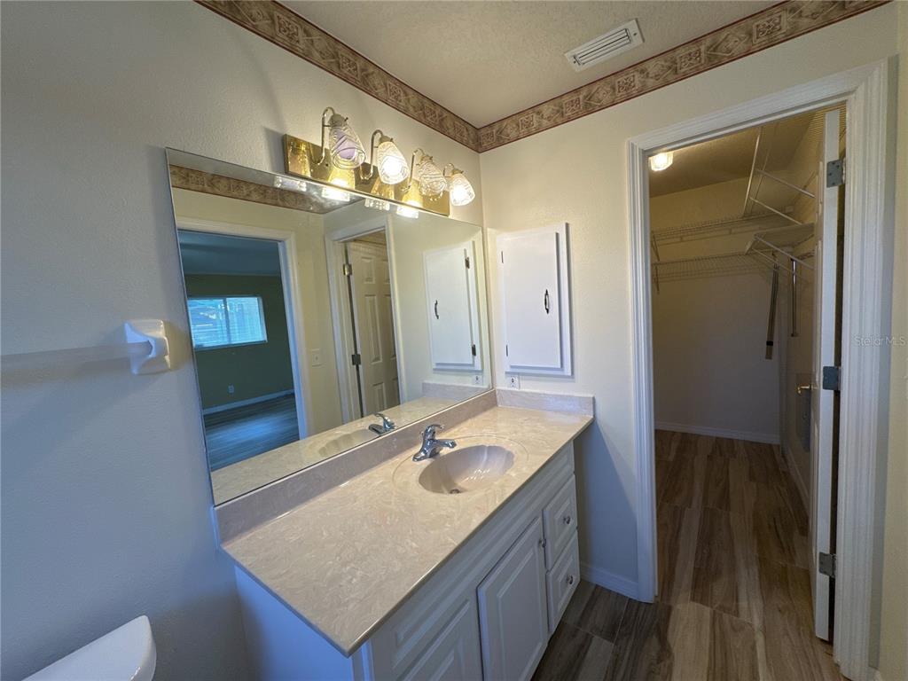 5440 Southwest 100th Loop Ocala, FL 34476 - Photo 24 of 37 a bathroom with a granite countertop sink and a mirror